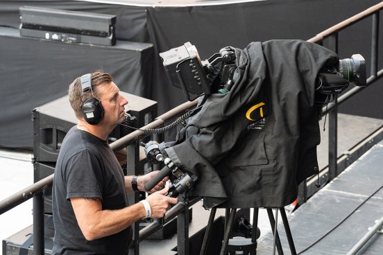 Camera operator filming a special performance for live screens and broadcast